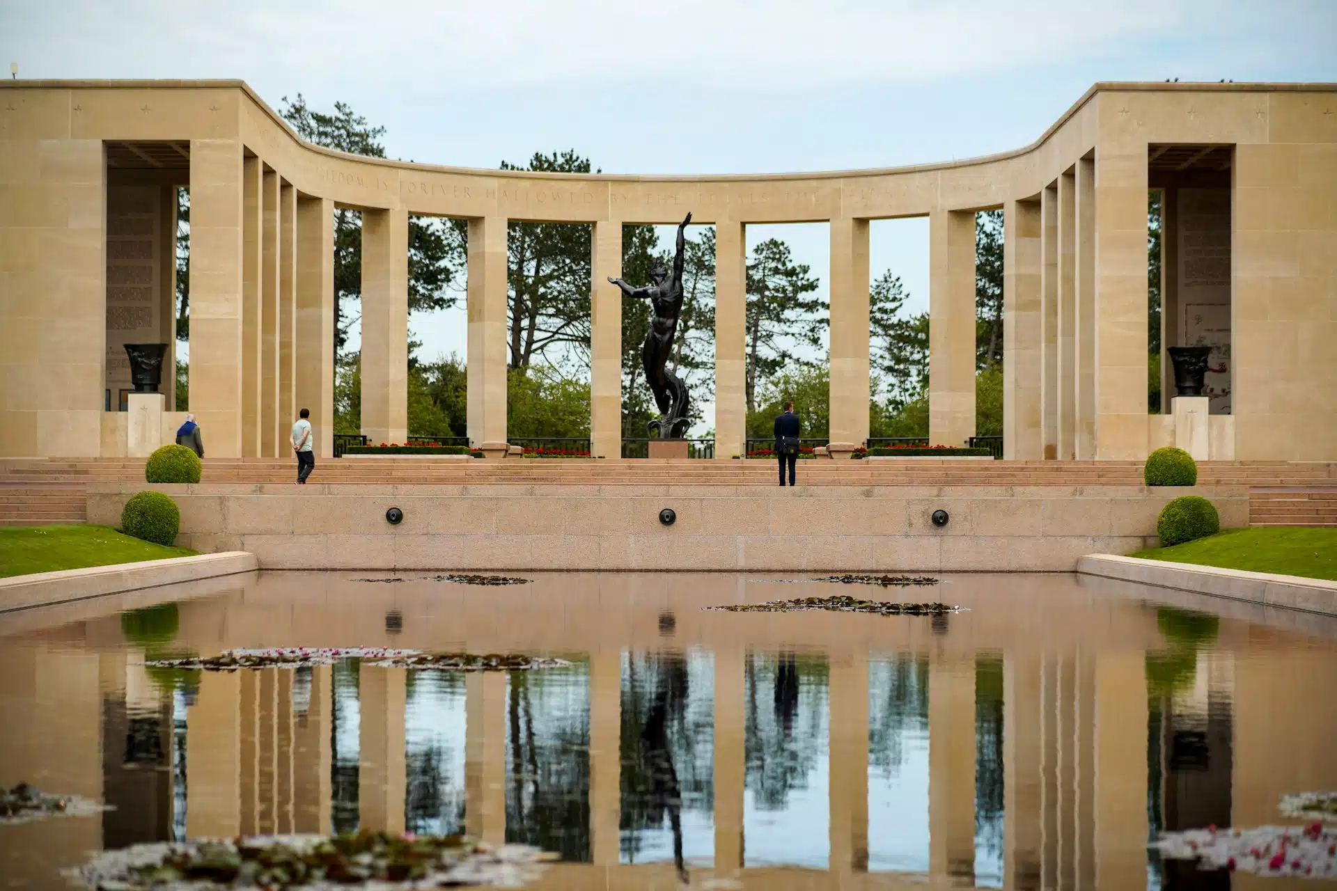 The memorial colonnade and its reflection at the Normandy American Cemetery