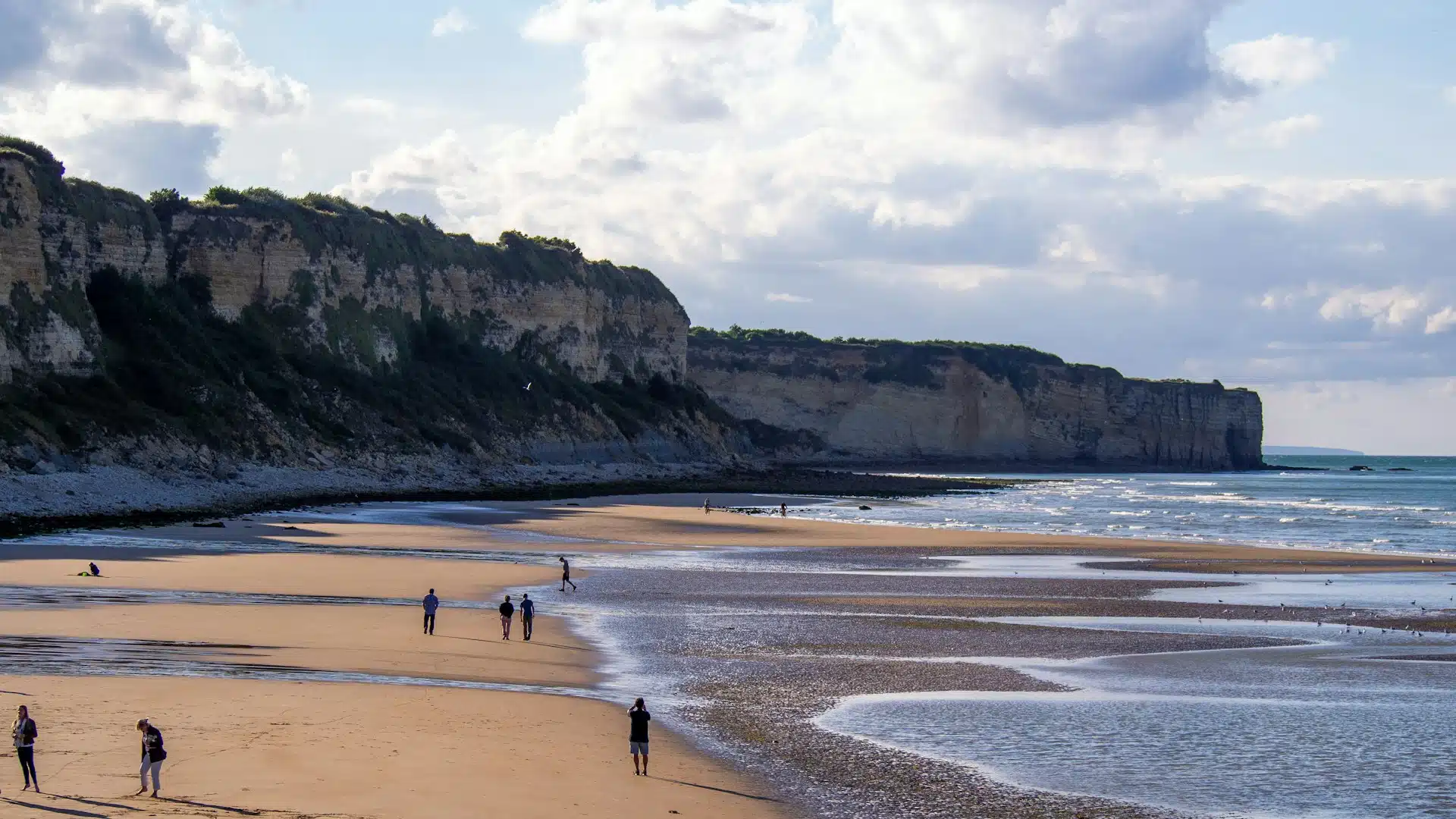 A Normandy coastal cliff overlooking the beach at low tide