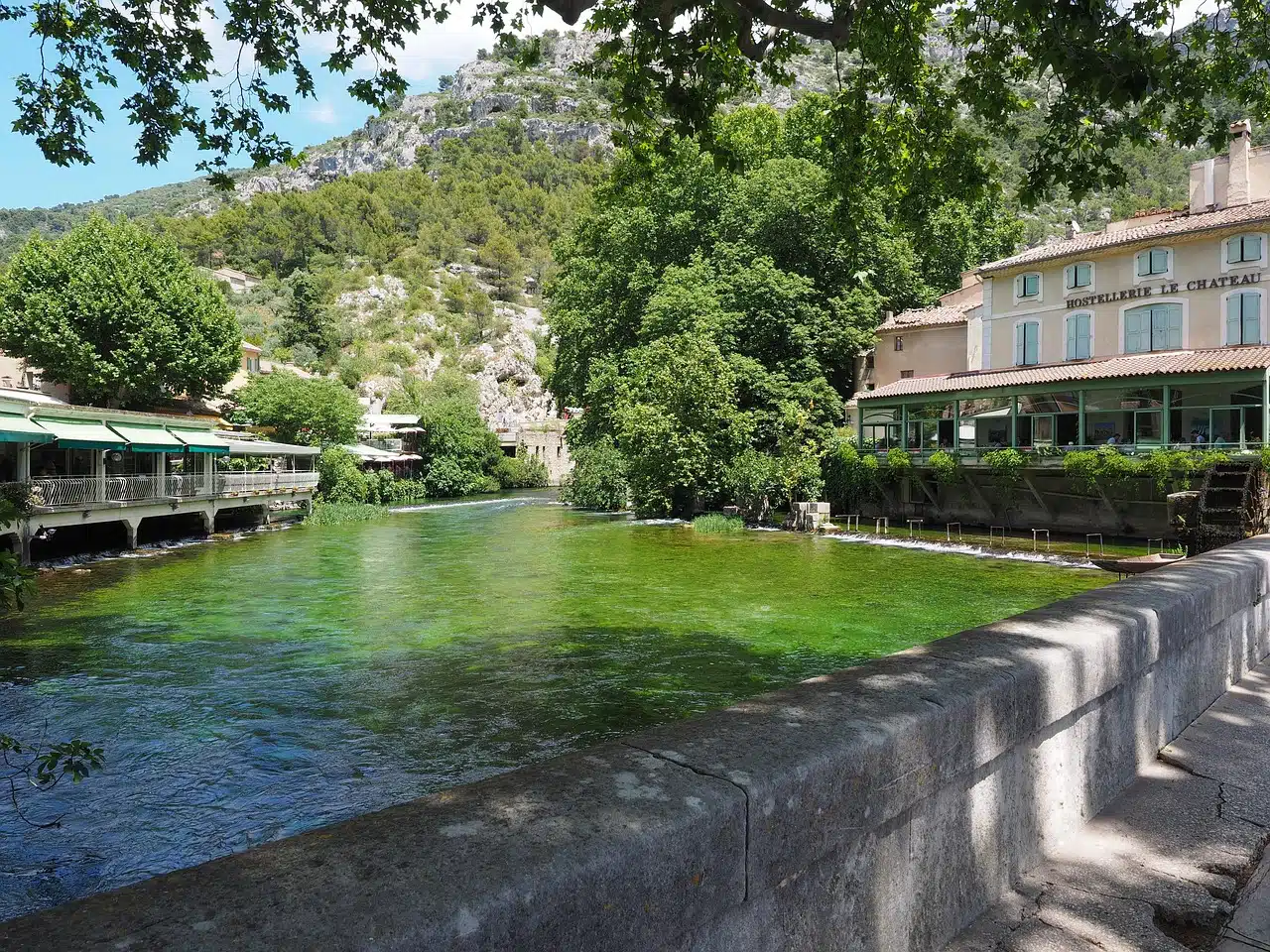 The green waters of the Sorgue in the village of Fontaine-de-Vaucluse