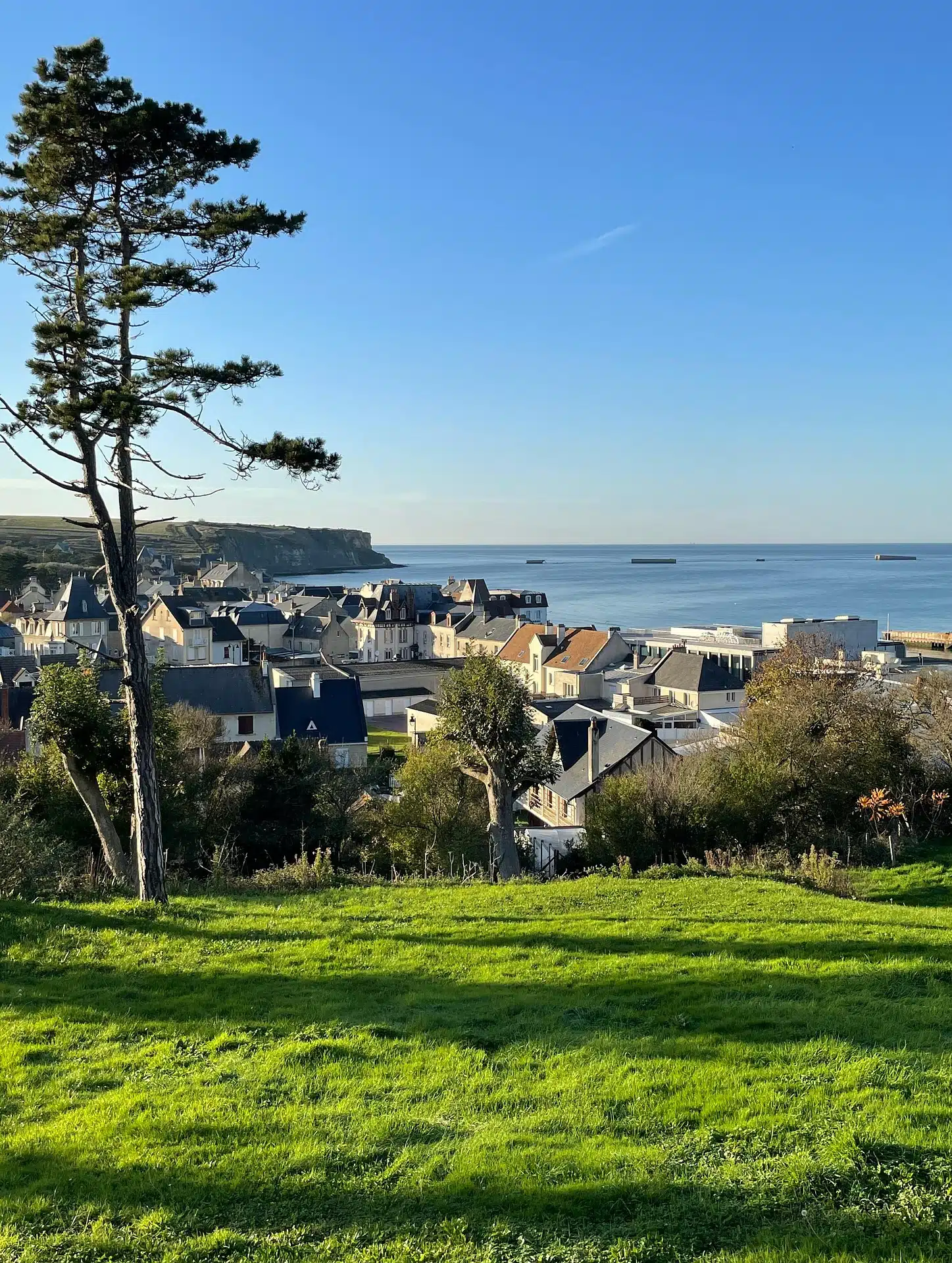 The heights above Arromanches with the remains of the artificial harbour in the distance