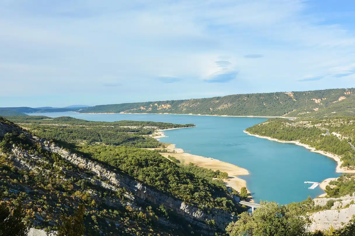 Blue water at Lac de Sainte-Croix below wooded hills