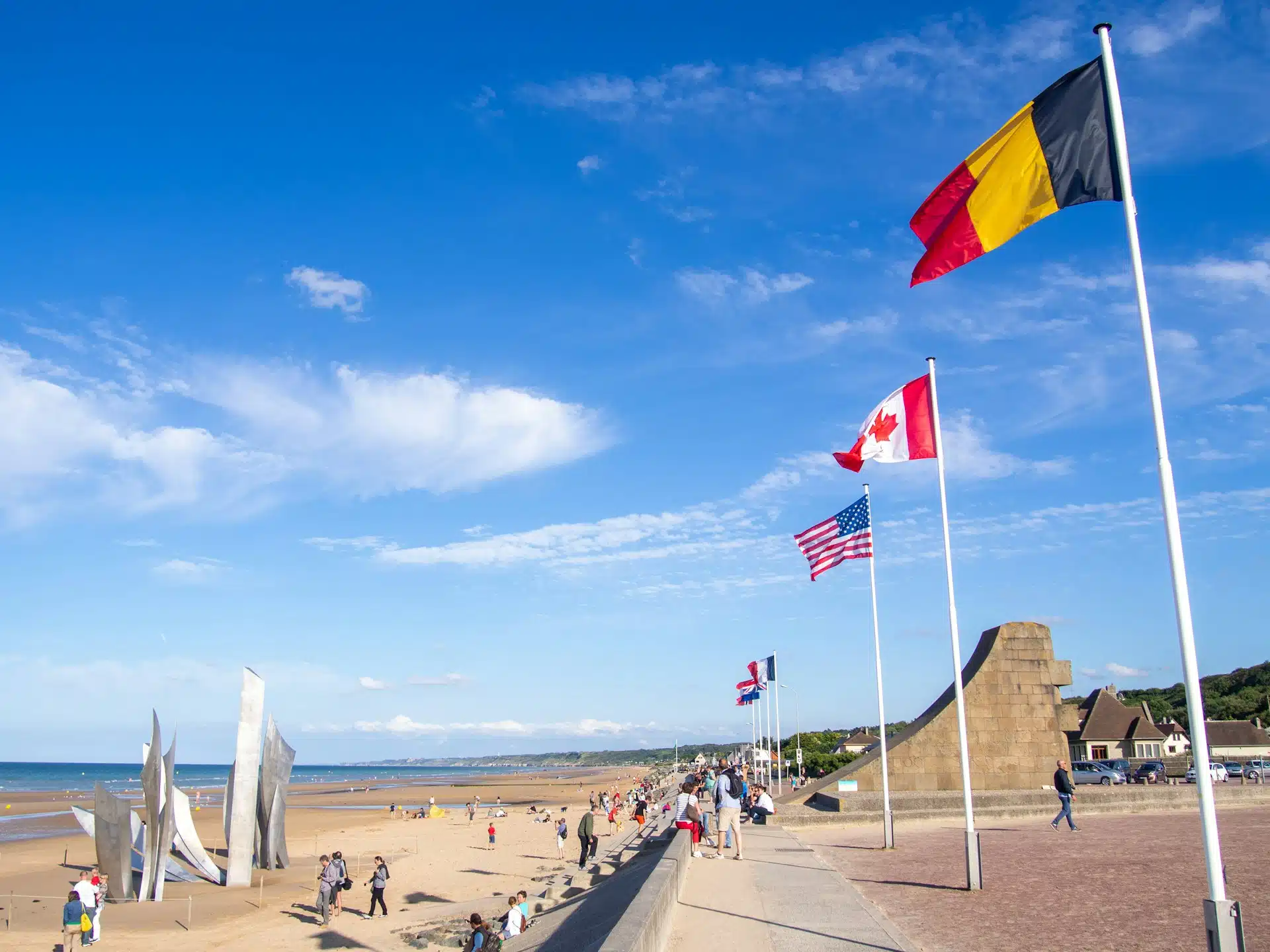The Omaha Beach esplanade and its flags, near the Les Braves sculpture