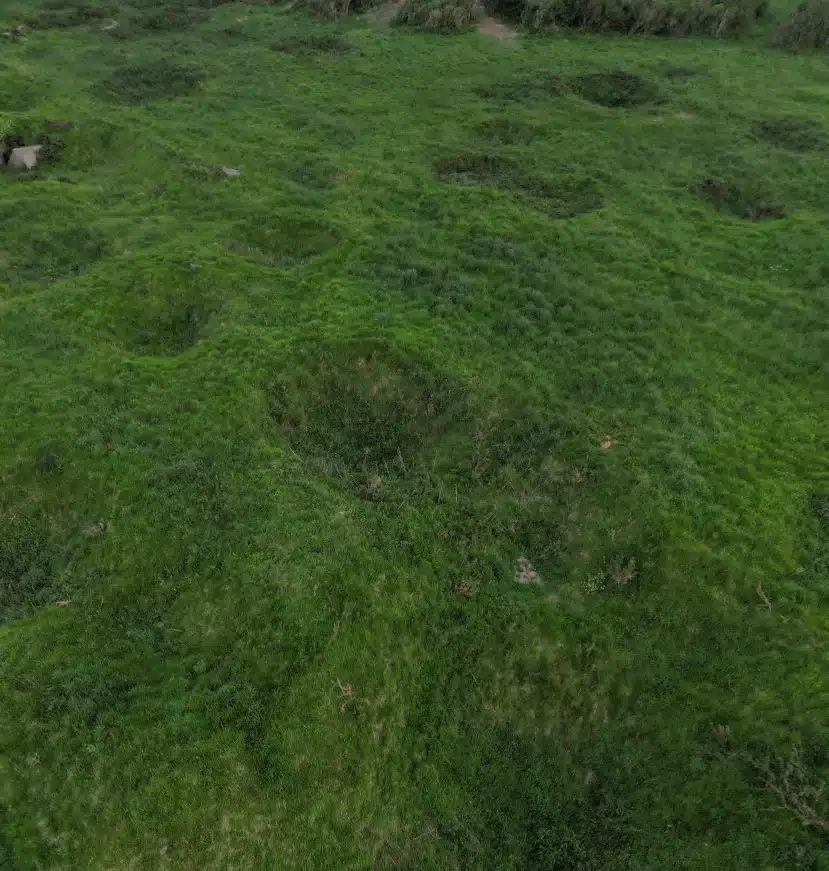 Aerial view of the bomb craters at Pointe du Hoc