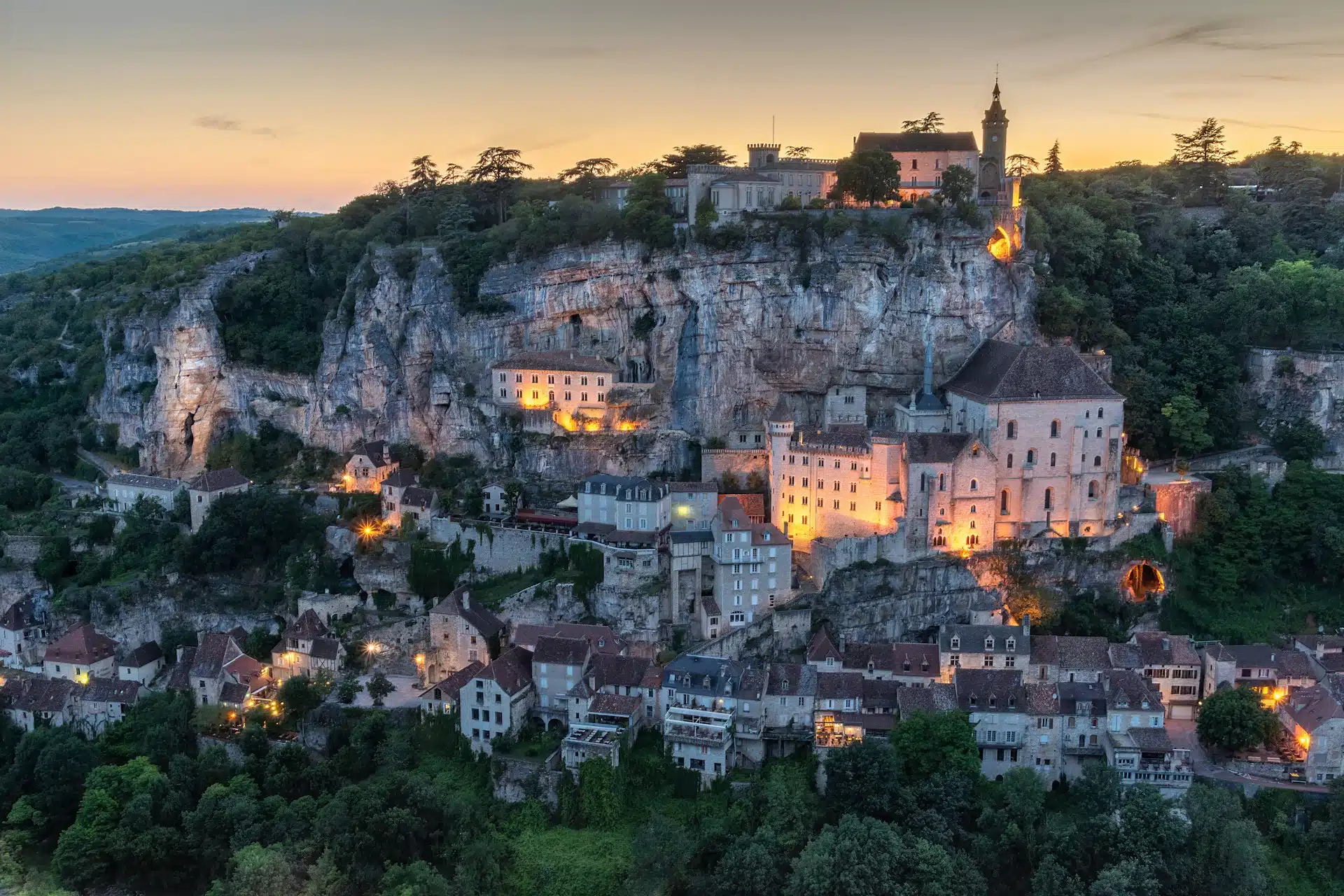 The town of Rocamadour clinging to its cliff at sunset