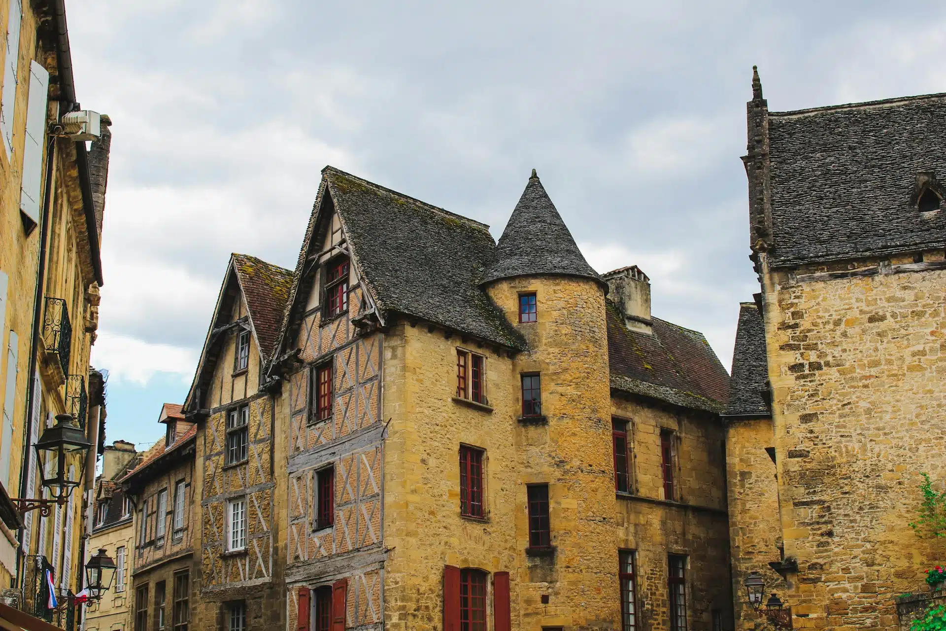 Old half-timbered houses and a turret in the old town of Sarlat